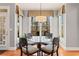 Cozy dining area features large windows, a glass top table, and stylish chairs for a warm, inviting atmosphere at 406 Greyfield Dr, Canton, GA 30115