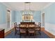 Formal dining room with elegant decor, wainscoting, and stylish chandelier at 406 Greyfield Dr, Canton, GA 30115