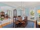 Elegant dining room with hardwood floors, modern light fixture, and bright windows at 406 Greyfield Dr, Canton, GA 30115