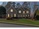 Charming two-story brick home with well-manicured lawn and inviting front porch, a perfect suburban oasis at 406 Greyfield Dr, Canton, GA 30115