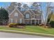 Charming two-story brick home with well-manicured lawn and inviting front porch, a perfect suburban oasis at 406 Greyfield Dr, Canton, GA 30115