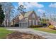 Exterior features a three-car garage and well-maintained landscaping at 406 Greyfield Dr, Canton, GA 30115