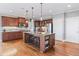 Spacious kitchen with wood floors, granite countertops, and stainless steel appliances at 406 Greyfield Dr, Canton, GA 30115