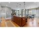 Kitchen features a large center island, stainless steel appliances, granite counters, and views of the stone fireplace at 406 Greyfield Dr, Canton, GA 30115