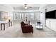 Well-lit living room with a leather couch, TV and lots of natural light at 406 Greyfield Dr, Canton, GA 30115