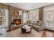 Cozy living room with stone fireplace, comfortable seating, and natural light creating a warm and inviting space at 406 Greyfield Dr, Canton, GA 30115