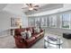 Comfortable living room with a leather couch and large windows at 406 Greyfield Dr, Canton, GA 30115