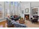 Spacious living room with a fireplace, large windows, and stylish décor at 406 Greyfield Dr, Canton, GA 30115