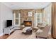 Comfortable living room with stone fireplace, large windows, and neutral tones creating a relaxing atmosphere at 406 Greyfield Dr, Canton, GA 30115