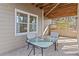 Back patio with glass table and 2 chairs provides a cozy outdoor seating area at 406 Greyfield Dr, Canton, GA 30115