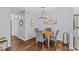 Bright dining area with hardwood floors, table and chairs illuminated by a modern chandelier at 1506 Country Park Se Dr, Smyrna, GA 30080