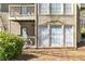 Exterior view featuring a small balcony, large windows, and mature landscaping at 1506 Country Park Se Dr, Smyrna, GA 30080