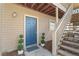 Front entrance with blue door, decorative topiaries, and wooden stairs at 1506 Country Park Se Dr, Smyrna, GA 30080
