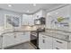 Modern kitchen with stainless steel appliances, gray countertops, and white cabinets at 1506 Country Park Se Dr, Smyrna, GA 30080