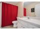 Bathroom featuring red shower curtain, vanity and mirror at 190 The Falls Blvd, Covington, GA 30016