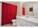 Bathroom with a red shower curtain, toilet, vanity and a mirror at 190 The Falls Blvd, Covington, GA 30016