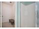 Bathroom featuring a shower with glass doors and a gray bench at 190 The Falls Blvd, Covington, GA 30016