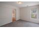 Comfortable bedroom with neutral carpet, natural light, and an open door to another room at 190 The Falls Blvd, Covington, GA 30016