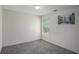 Neutral bedroom featuring gray carpeting and window at 190 The Falls Blvd, Covington, GA 30016