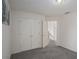 Bedroom featuring gray carpeting, a closet, and view of the staircase at 190 The Falls Blvd, Covington, GA 30016