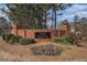 Landscaped community entrance with brick sign reading 'The Falls' and featuring seasonal flowers at 190 The Falls Blvd, Covington, GA 30016