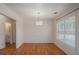 Bright dining room with hardwood floors, wainscoting, and modern chandelier at 190 The Falls Blvd, Covington, GA 30016