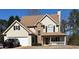 Charming two-story home featuring a front porch, attached garage, and stone accents at 190 The Falls Blvd, Covington, GA 30016