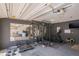 A home gym complete with a large mirror, rubber flooring, and weightlifting equipment at 190 The Falls Blvd, Covington, GA 30016