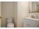 Cozy half bathroom featuring white vanity, modern faucet, and decorative mirror at 190 The Falls Blvd, Covington, GA 30016