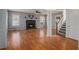 Large living room with hardwood floors, staircase, and fireplace at 190 The Falls Blvd, Covington, GA 30016