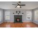 Comfortable living room with a stone fireplace and large windows offering bright natural light at 190 The Falls Blvd, Covington, GA 30016