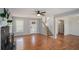 Open living room featuring wood floors, a fireplace, and a staircase at 190 The Falls Blvd, Covington, GA 30016
