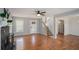 Cozy living room featuring a fireplace, hardwood floors, staircase and ample sunlight at 190 The Falls Blvd, Covington, GA 30016