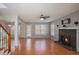 Spacious living room with hardwood floors, stone fireplace, and lots of natural light at 190 The Falls Blvd, Covington, GA 30016