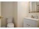 Clean and simple powder room with toilet and vanity at 190 The Falls Blvd, Covington, GA 30016