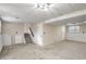 Spacious basement area with carpet, white brick accents and stairs to the upper level at 3265 Newcastle Way, Snellville, GA 30039