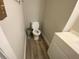 Small bathroom with toilet, vanity and wood-look flooring, offers functionality at 3265 Newcastle Way, Snellville, GA 30039