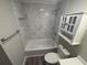 Renovated bathroom boasts a tiled shower, modern vanity, and updated fixtures at 3265 Newcastle Way, Snellville, GA 30039