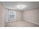 A basic bedroom view features carpeted floors, neutral colored walls and trim, and a window view at 3265 Newcastle Way, Snellville, GA 30039