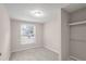 A simple bedroom view with a window view and a closet with shelves at 3265 Newcastle Way, Snellville, GA 30039