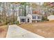 Inviting two-story home with long driveway, neutral siding, and dark shutters nestled among trees at 3265 Newcastle Way, Snellville, GA 30039
