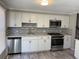 Updated kitchen features stainless steel appliances, modern cabinets, and a stylish backsplash at 3265 Newcastle Way, Snellville, GA 30039