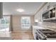 Bright kitchen with white cabinetry, stainless steel appliances, and sliding door to the patio at 3265 Newcastle Way, Snellville, GA 30039