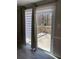 Patio door leading to an outdoor deck, complemented by neutral curtains and privacy blinds at 3265 Newcastle Way, Snellville, GA 30039