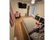 Bedroom featuring hardwood floors, wall-mounted TV, and storage at 4034 Weeks Nw Dr, Kennesaw, GA 30144