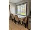 Dining area featuring a table setting, large window, and neutral color palette at 4034 Weeks Nw Dr, Kennesaw, GA 30144