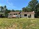 View of home's exterior with a covered deck and expansive grassy yard at 4034 Weeks Nw Dr, Kennesaw, GA 30144