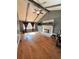 Spacious living room with vaulted ceilings, brick fireplace, and hardwood flooring at 4034 Weeks Nw Dr, Kennesaw, GA 30144