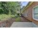 Backyard featuring a brick house with a concrete patio at 6000 E Andechs Smt, Johns Creek, GA 30097