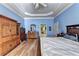 Bright bedroom with hardwood floors and detailed trim, leading to a bathroom at 6000 E Andechs Smt, Johns Creek, GA 30097